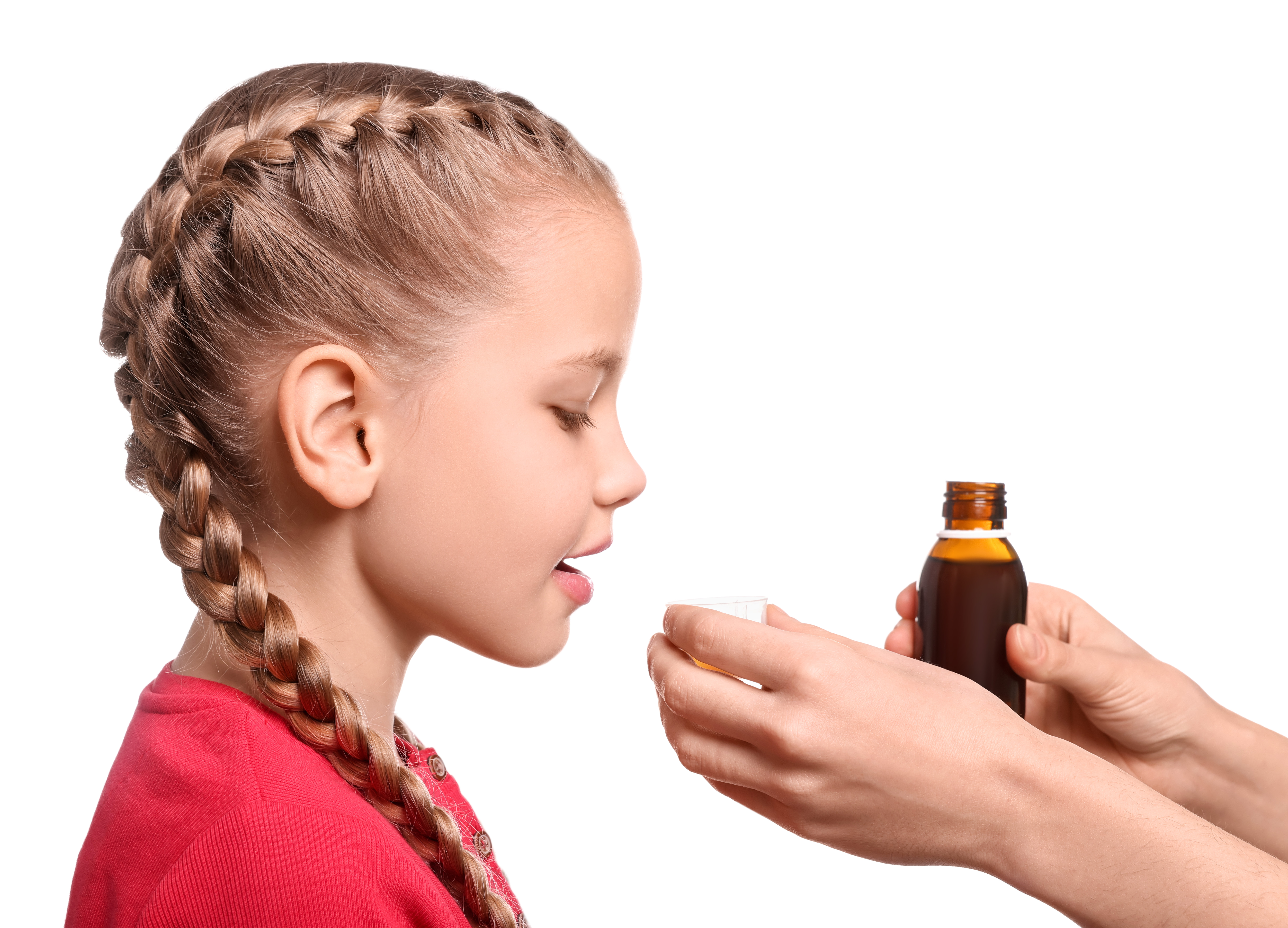 mother-giving-syrup-daughter-from-measuring-cup-against-white-background